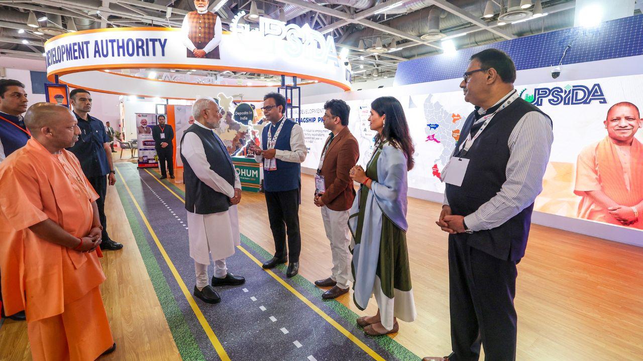 Prime Minister Narendra Modi and CM Yogi Adityanath interact with officials at the exhibition during the inauguration of the Uttar Pradesh International Trade Show 2025 in Greater Noida